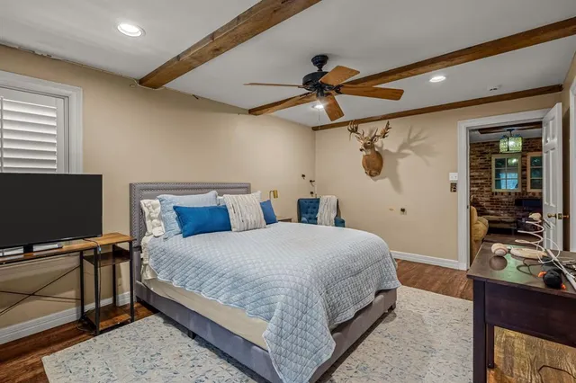 a bedroom with a bed and a flat screen tv