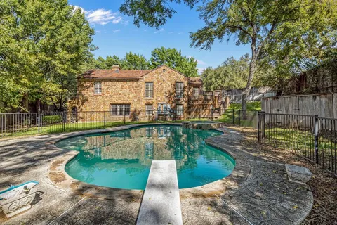 a view of a swimming pool with a patio