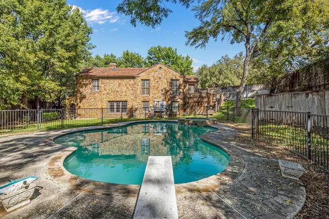 a view of a swimming pool with a patio