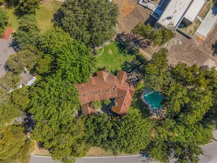 an aerial view of a house with a yard and garden