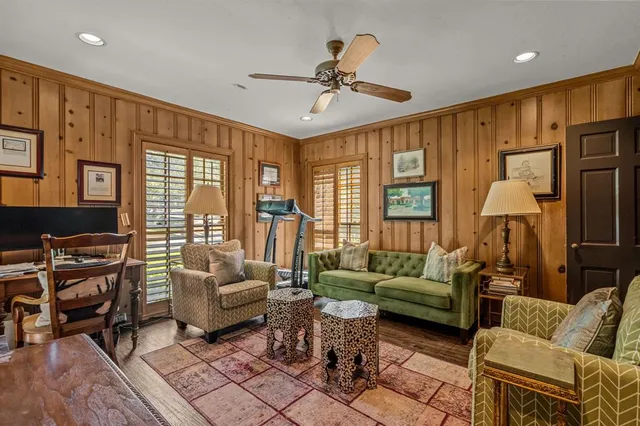 a living room with furniture ceiling fan and a window