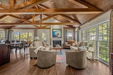 a living room with fireplace furniture and a wooden floor