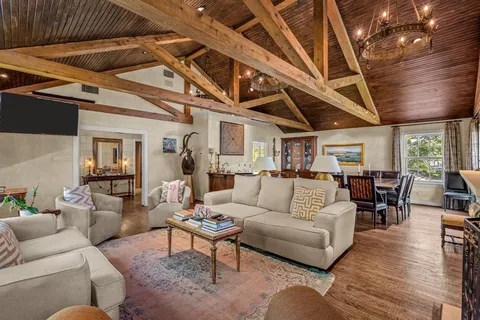 a living room with furniture wooden floor and dining table