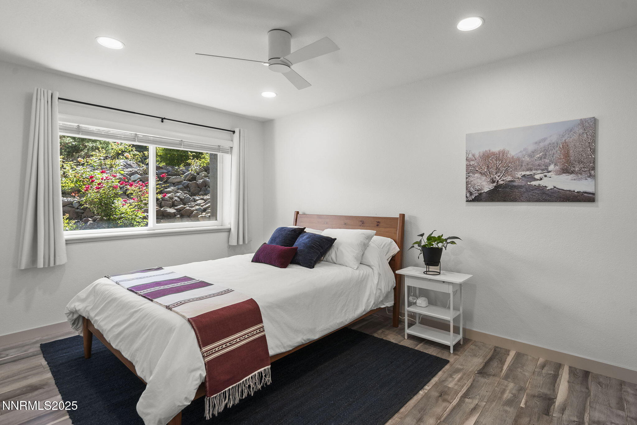 2885 Erminia Road Reno, NV 89523 - Photo 27 of 38 a bedroom with a bed and a painting on the wall
