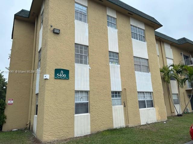 5400 Southwest 77th Court, Unit 2R Miami, FL 33155 - Photo 2 of 18 a front view of a house with a yard