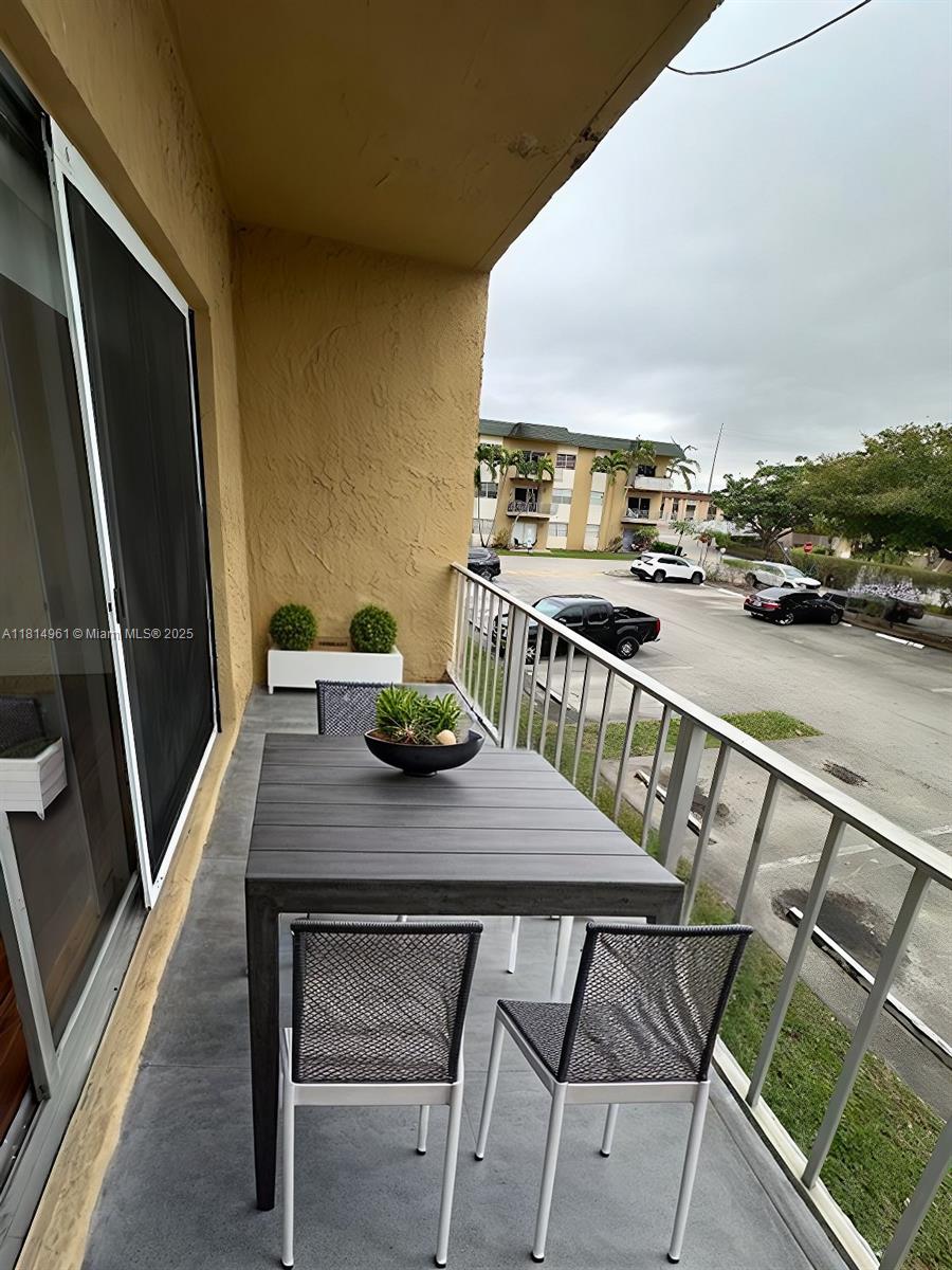 5400 Southwest 77th Court, Unit 2R Miami, FL 33155 - Photo 7 of 18 a view of a patio with table and chairs