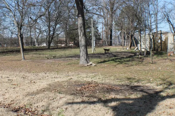 a view of outdoor space with wooden fence