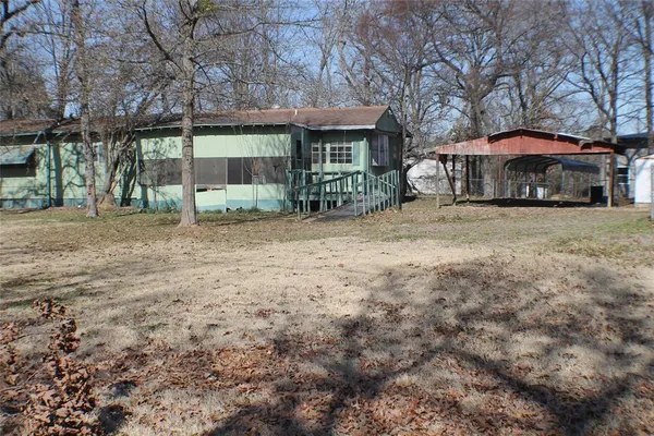 a front view of a house with yard and porch