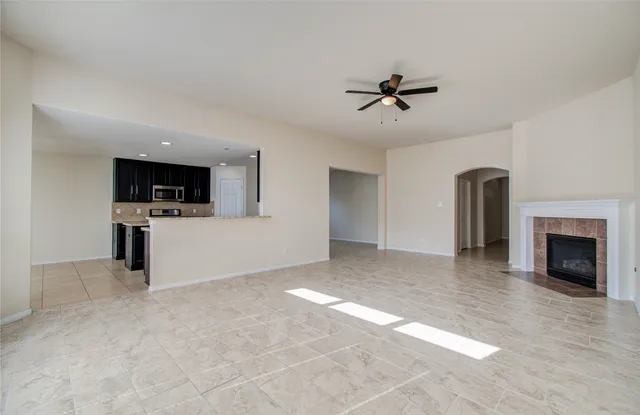 a view of a livingroom with a fireplace a sink and dishwasher kitchen view