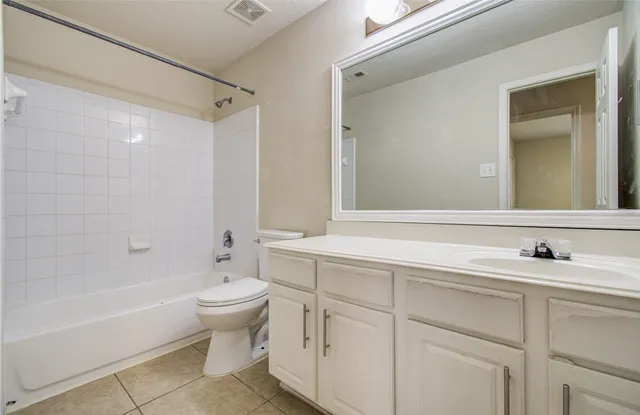 a bathroom with a double vanity sink toilet mirror and bathtub