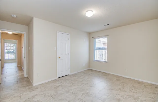an empty room with windows and closet