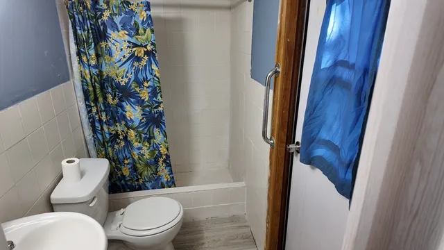 a white toilet sitting next to a small bathroom