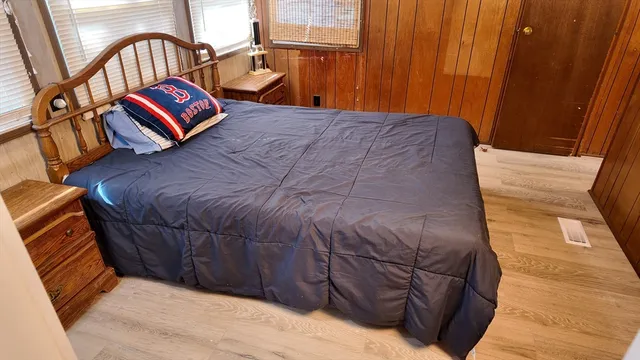 a bedroom with a bed and a mirror