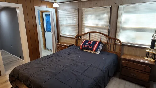 a bedroom with a bed next to a window