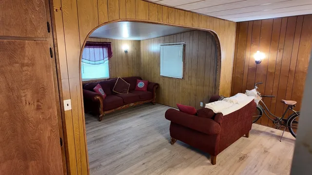 a living room with furniture and a chandelier