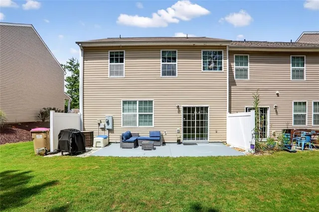 a backyard of a house with table and chairs