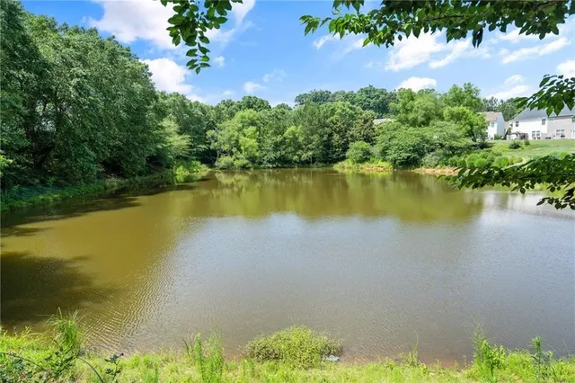 an aerial view of a house with a yard and lake view