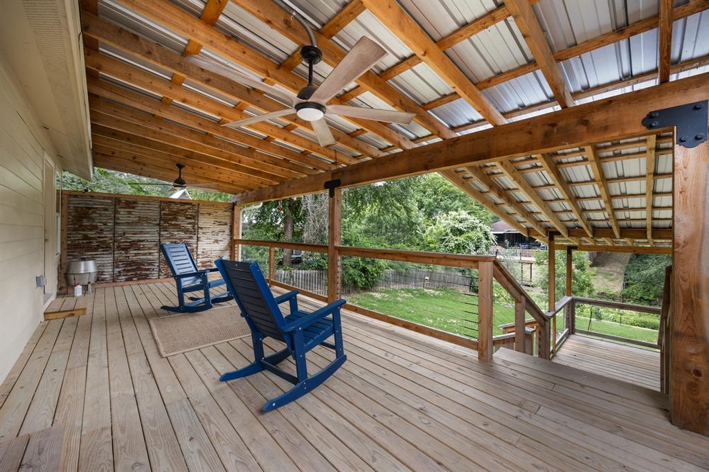114 Ricky Road Gun Barrel City, TX 75156 - Photo 18 of 18 Expansive outdoor deck featuring wood-finish flooring, a wood beam ceiling with a metal roof, and integrated ceiling fans