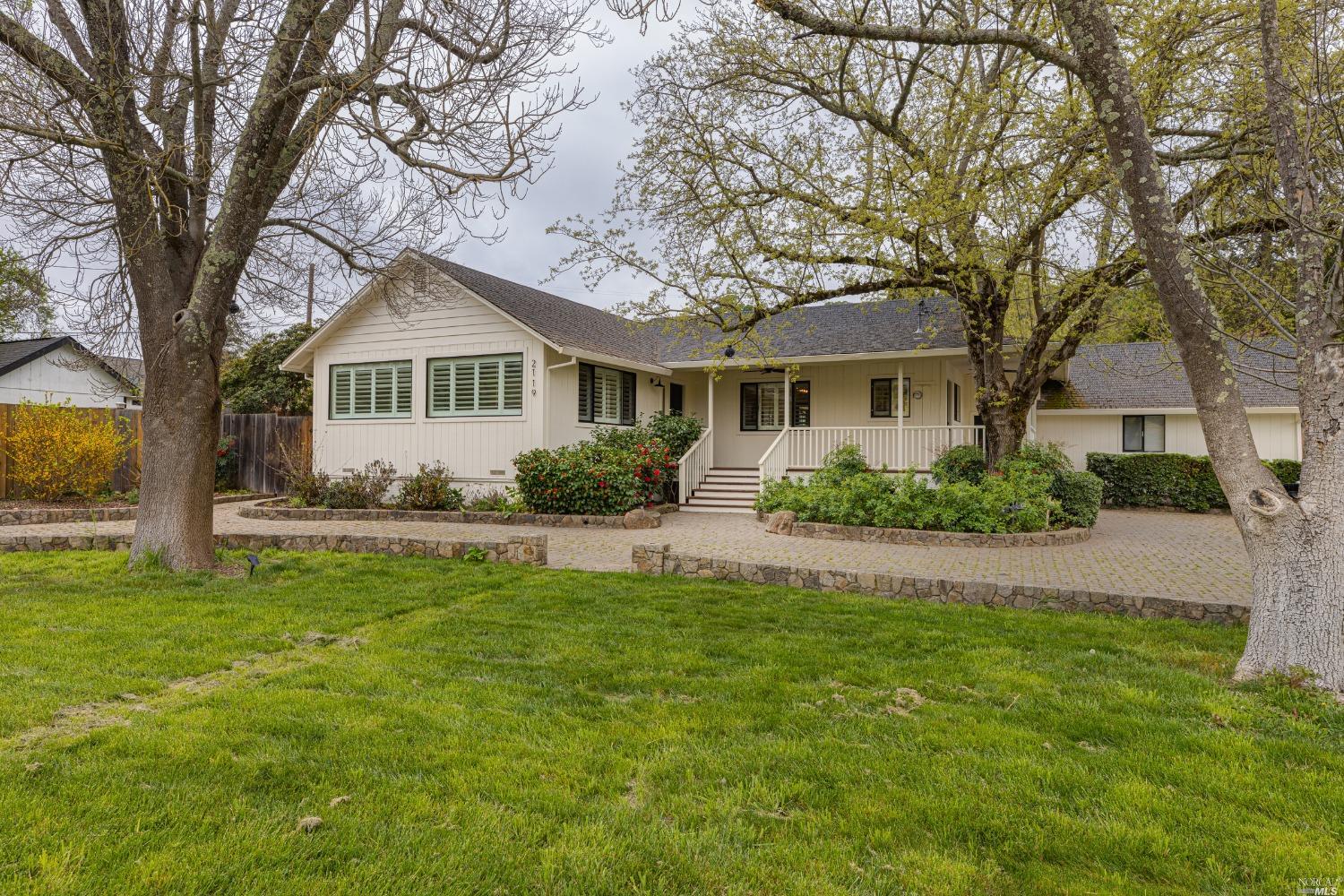 a front view of a house with a garden