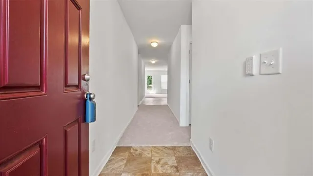 a view of a hallway with wooden walls