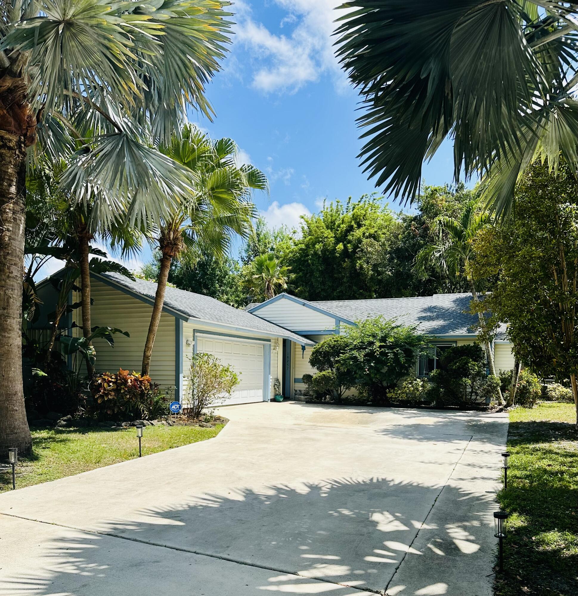 18257 Jupiter Landings Drive Jupiter, FL 33458 - Photo 1 of 43 a front view of a house with a yard and a garage