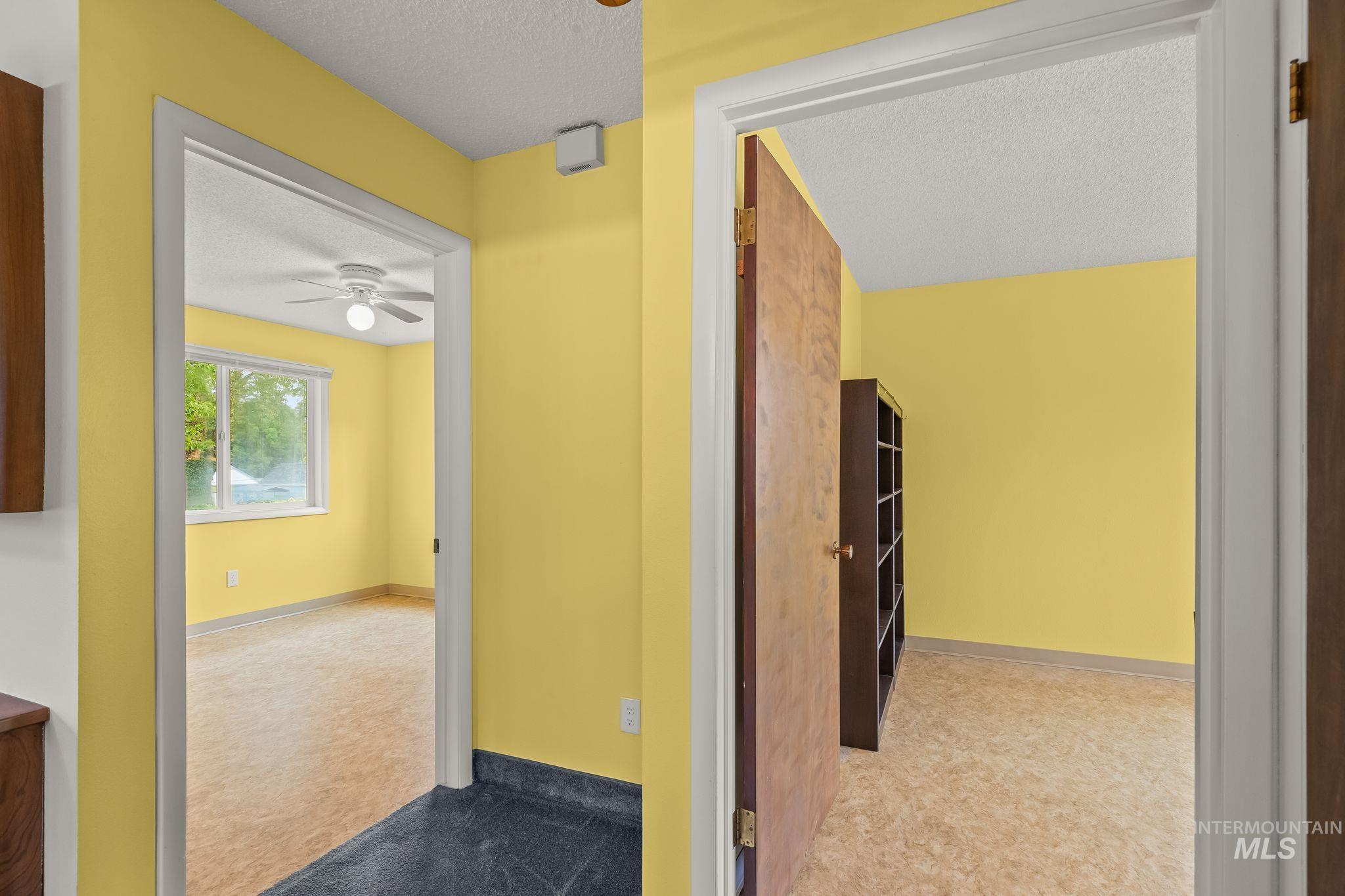 1721 3rd Street Lewiston, ID 83501 - Photo 44 of 45 Interior doorways providing access to multiple rooms featuring neutral wall tones, a ceiling fan with integrated lighting, and multiple windows