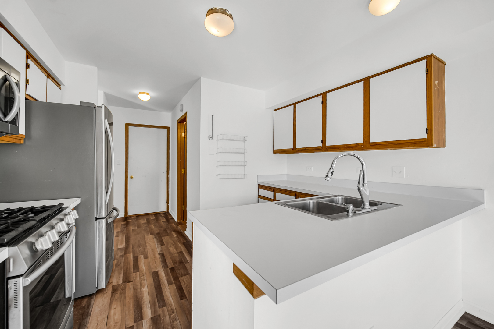 55 King Drive Streamwood, IL 60107 - Photo 4 of 18 a kitchen with a sink a stove and a refrigerator