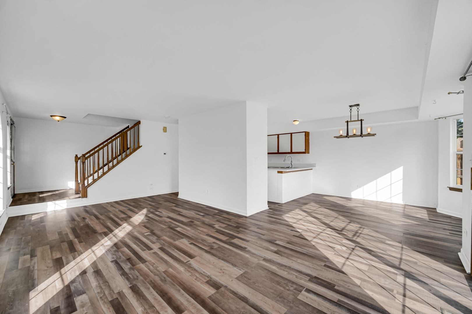 55 King Drive Streamwood, IL 60107 - Photo 6 of 18 a view of a bedroom with wooden floor and kitchen