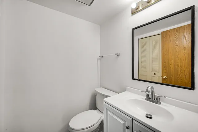 a bathroom with a sink a toilet and mirror