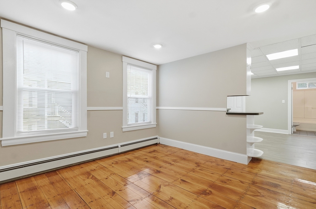 163-165 Chestnut Street Waltham, MA 02453 - Photo 14 of 41 wooden floor in an empty room with a window