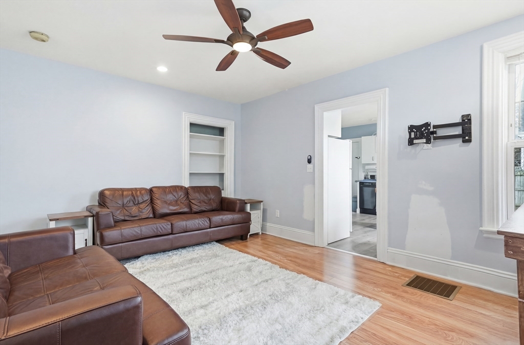 163-165 Chestnut Street Waltham, MA 02453 - Photo 19 of 41 a living room with furniture and a wooden floor