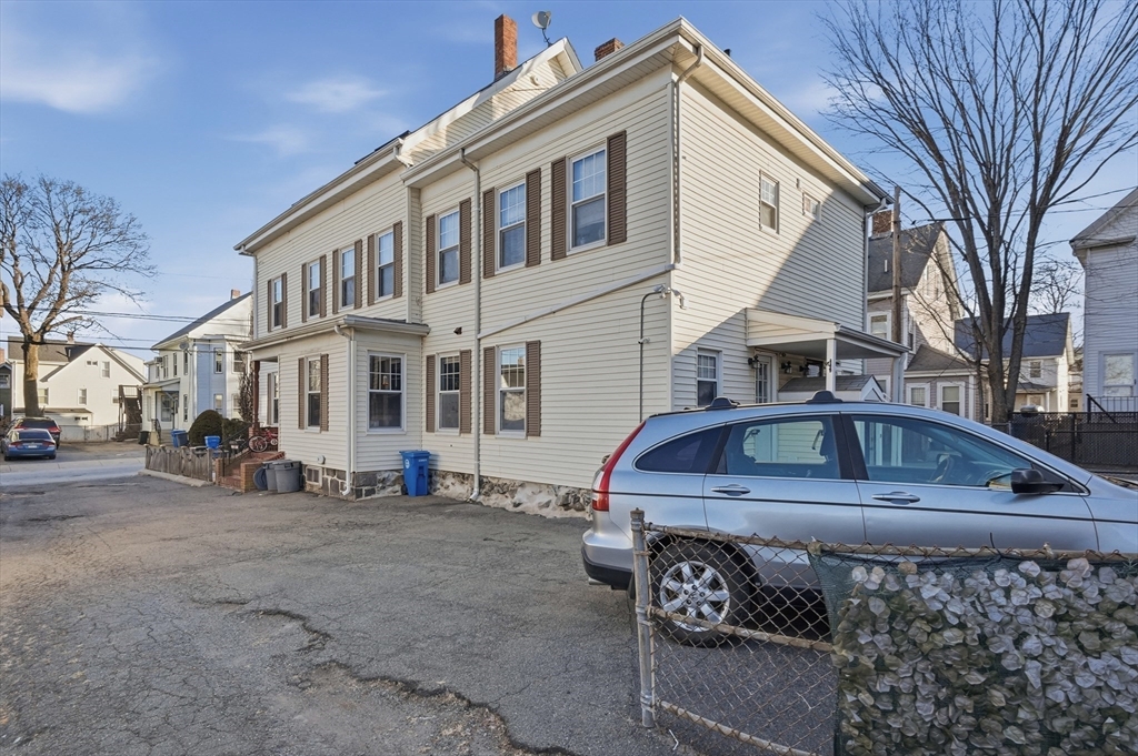 163-165 Chestnut Street Waltham, MA 02453 - Photo 2 of 41 a front view of a house with cars parked