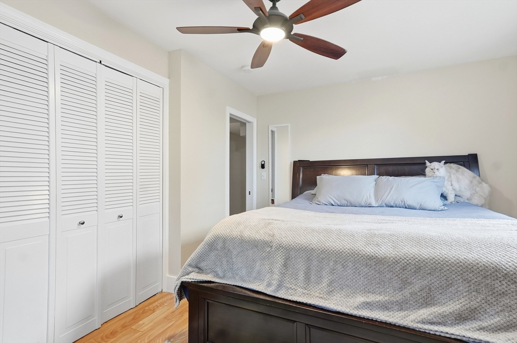 163-165 Chestnut Street Waltham, MA 02453 - Photo 21 of 41 a bedroom with a bed and wooden floor