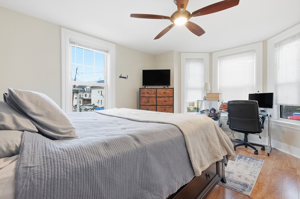 163-165 Chestnut Street Waltham, MA 02453 - Photo 22 of 41 a bedroom with a bed and a chair