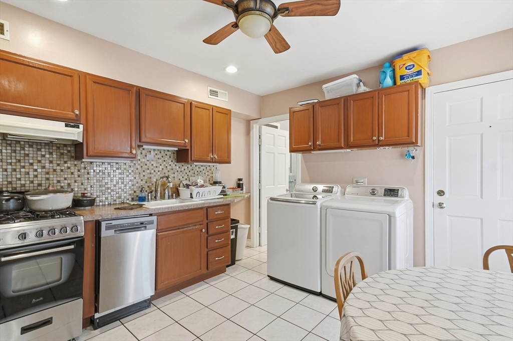 163-165 Chestnut Street Waltham, MA 02453 - Photo 28 of 41 a kitchen with stainless steel appliances granite countertop a stove a sink dishwasher and a refrigerator