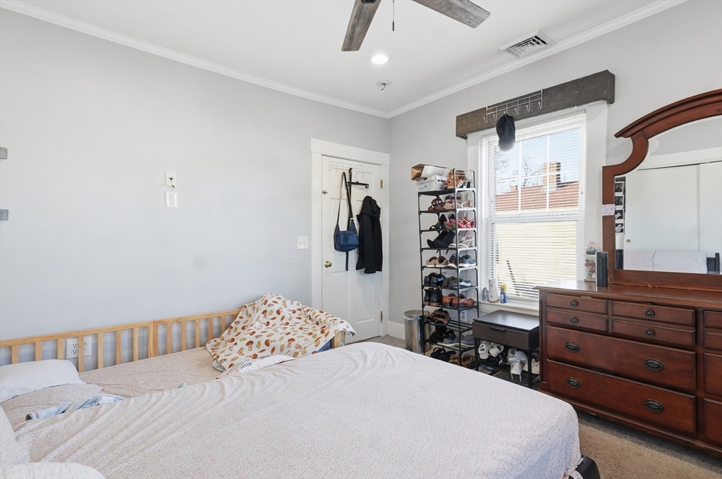 163-165 Chestnut Street Waltham, MA 02453 - Photo 31 of 41 a bedroom with a large bed and a window