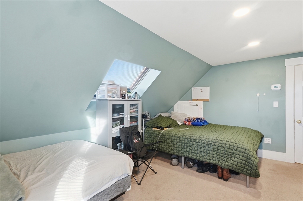 163-165 Chestnut Street Waltham, MA 02453 - Photo 33 of 41 a bedroom with a bed wooden floor and window