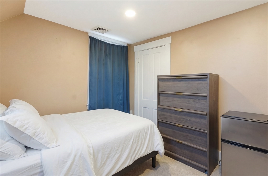 163-165 Chestnut Street Waltham, MA 02453 - Photo 35 of 41 a bedroom with a bed and cabinets