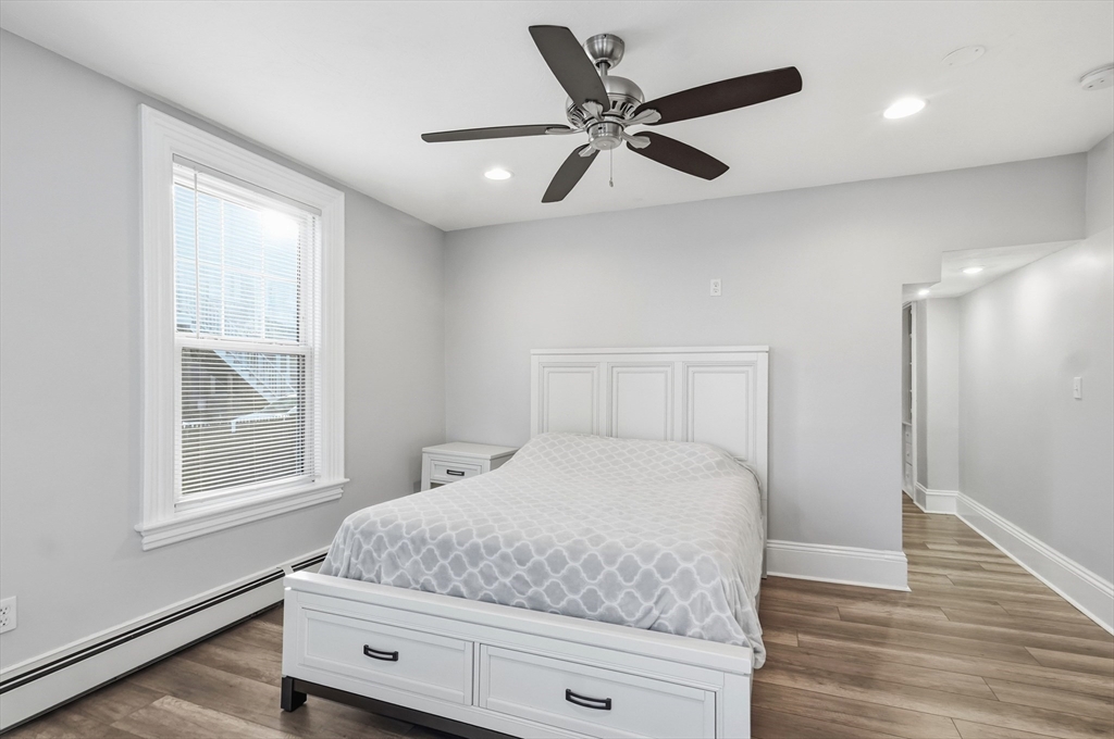 163-165 Chestnut Street Waltham, MA 02453 - Photo 8 of 41 a bedroom with a large bed and a window