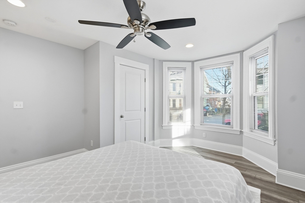163-165 Chestnut Street Waltham, MA 02453 - Photo 9 of 41 a spacious bedroom with a bed and a window