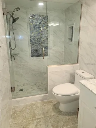 a bathroom with a toilet and a shower