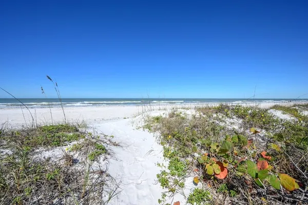 an outdoor space with furniture and ocean view