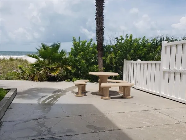 a view of a patio with a table and chairs