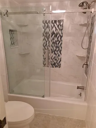 a bathroom with a shower and a bath tub