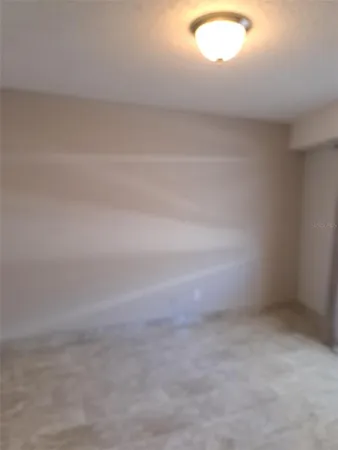 a view of wooden floor and chandelier in hallway