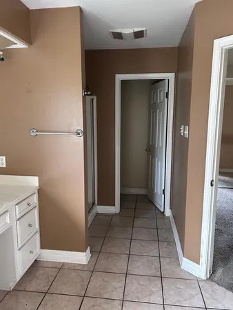 a view of a kitchen with white cabinets