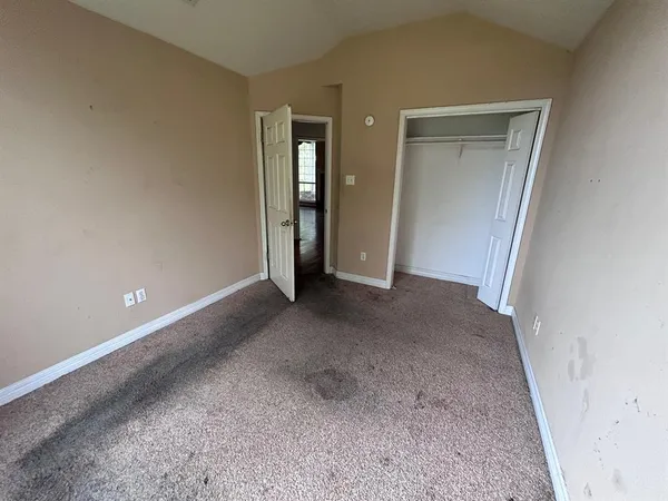 a view of an empty room and closet area