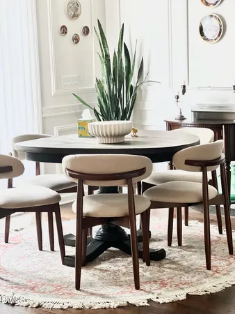 a view of a dining room with furniture and a potted plant