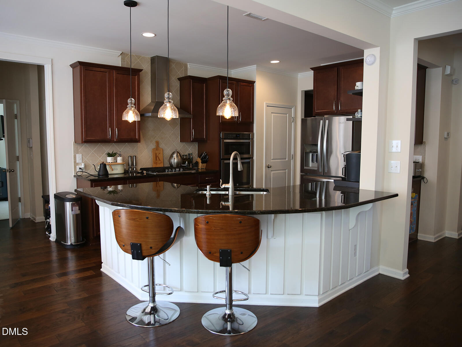 101 Inkwood Place Cary, NC 27519 - Photo 12 of 35 a kitchen with stainless steel appliances kitchen island granite countertop a table chairs and a refrigerator