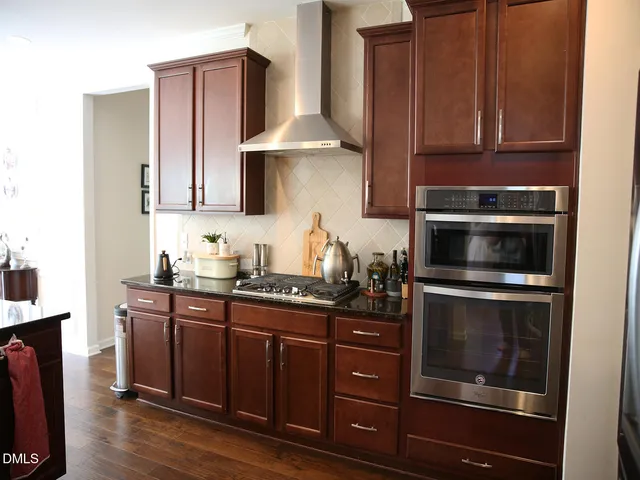 a kitchen with stainless steel appliances a stove a microwave and cabinets